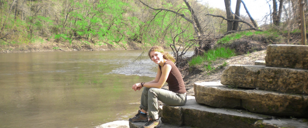 Adult female hiker resting along river at Pictured Rocks Park